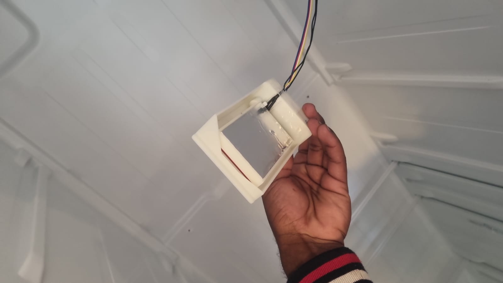 Faulty air damper removed from an AEG side-by-side fridge in Midrand before replacement