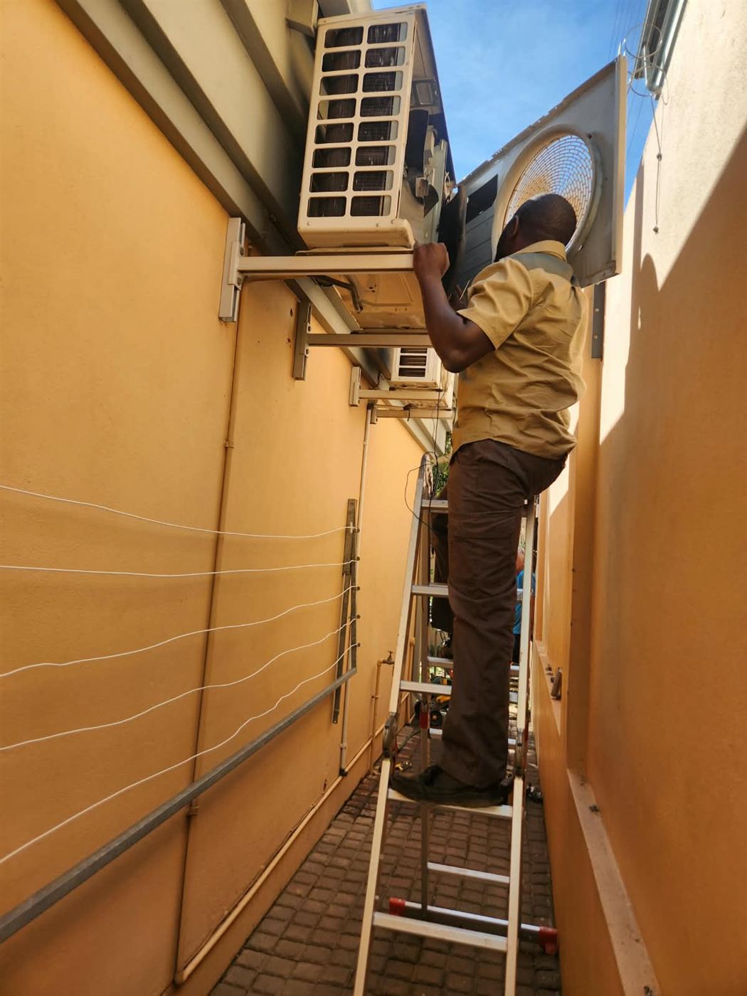Aircon outdoor unit being repaired in Randburg