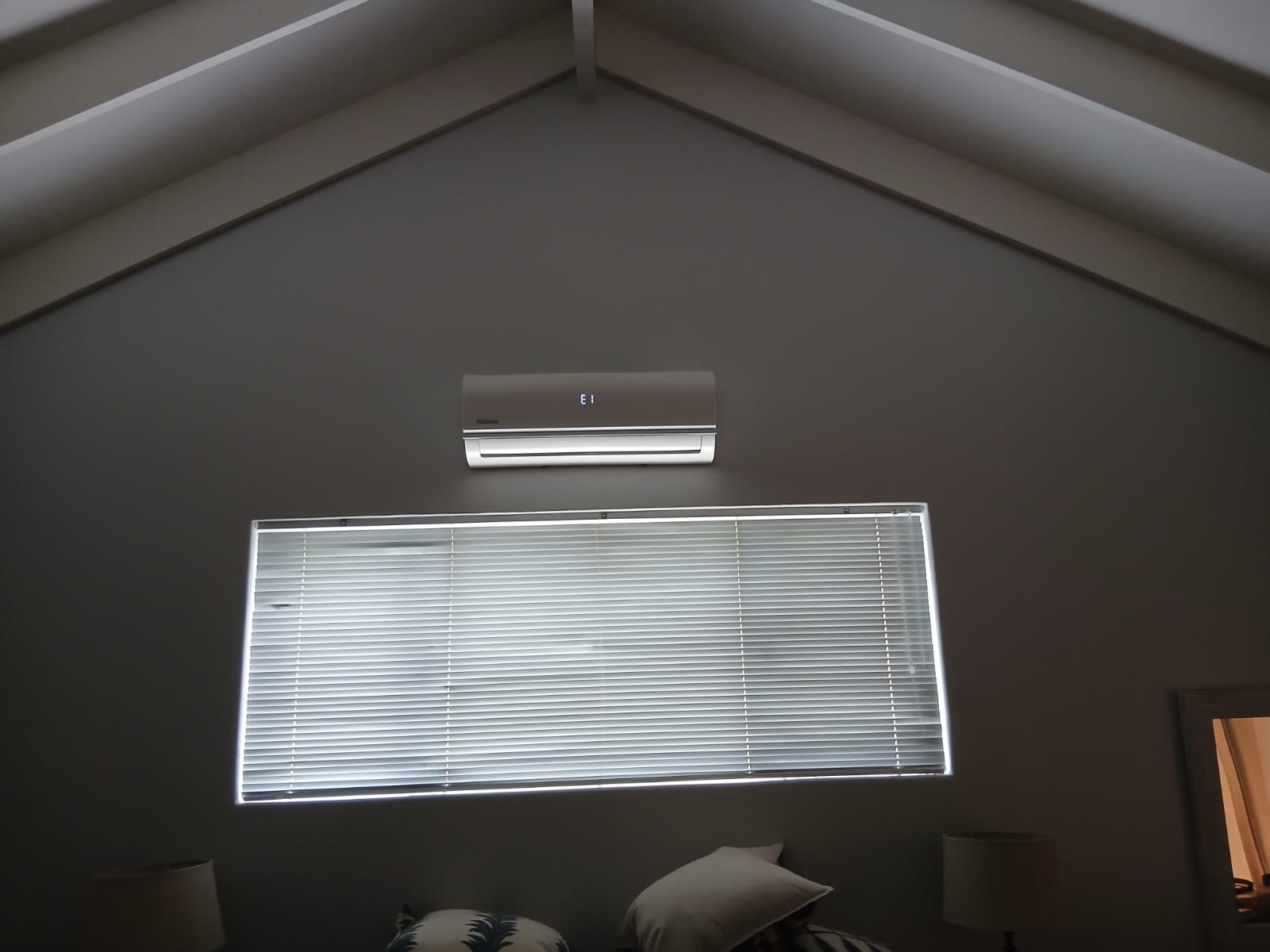 Alliance split aircon indoor unit showing the E1 error code in a Kempton Park bedroom
