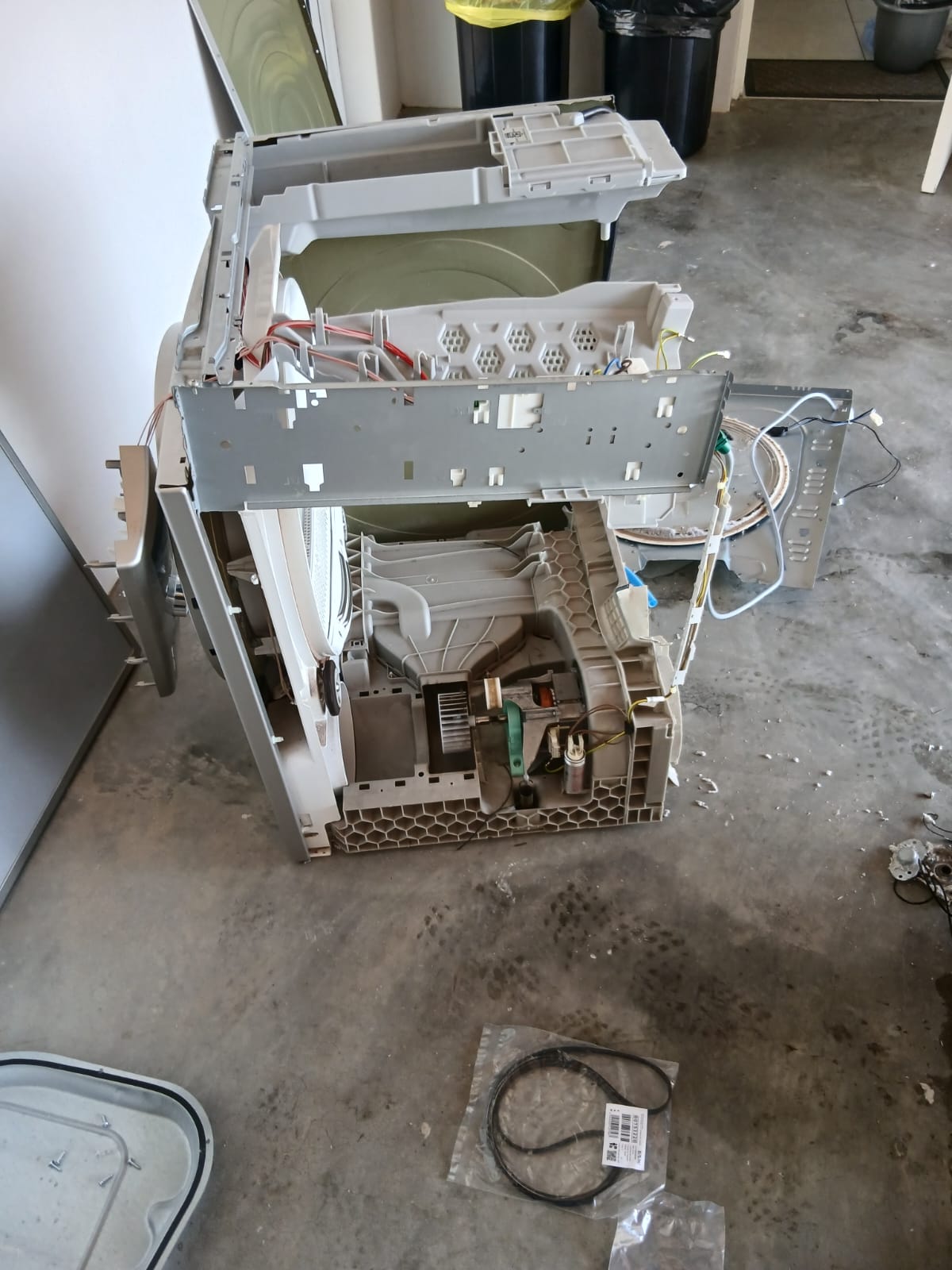 Bosch Serie 6 tumble dryer stripped down for a drive belt replacement in Springs, with the new belt in its packet