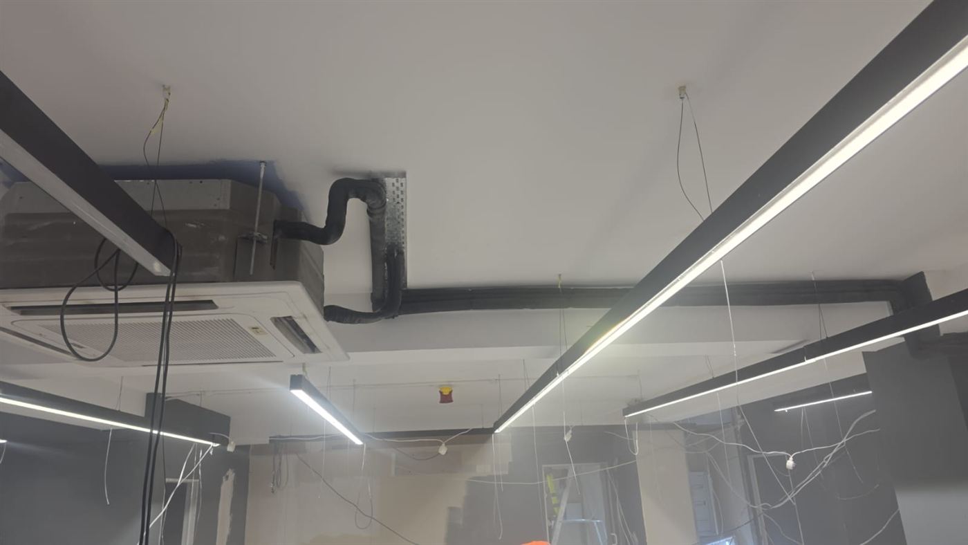 Insulated aircon pipework run across the ceiling from a cassette unit