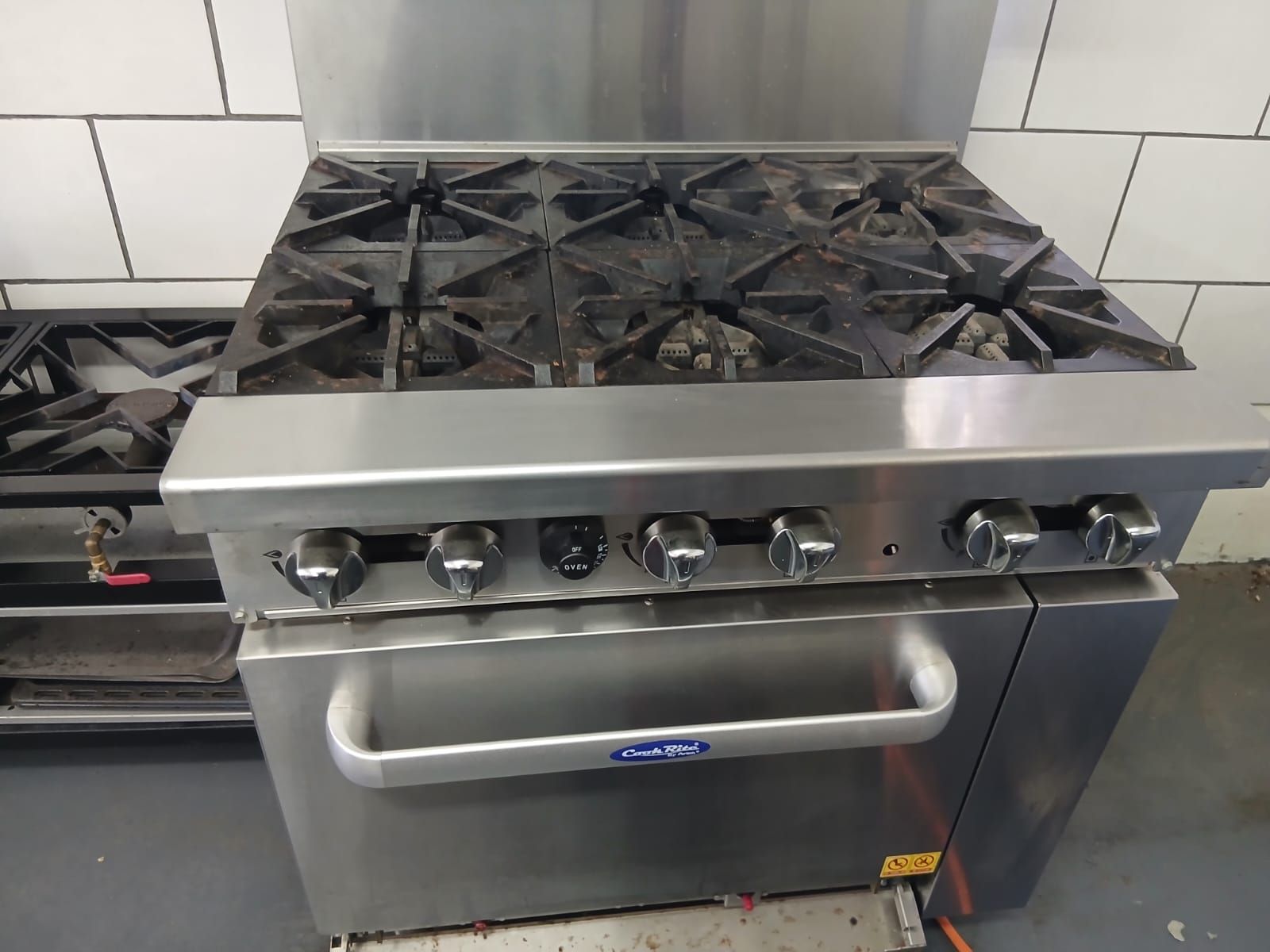 Cook Rite six-burner commercial gas range in a Randburg kitchen with grime on the burners