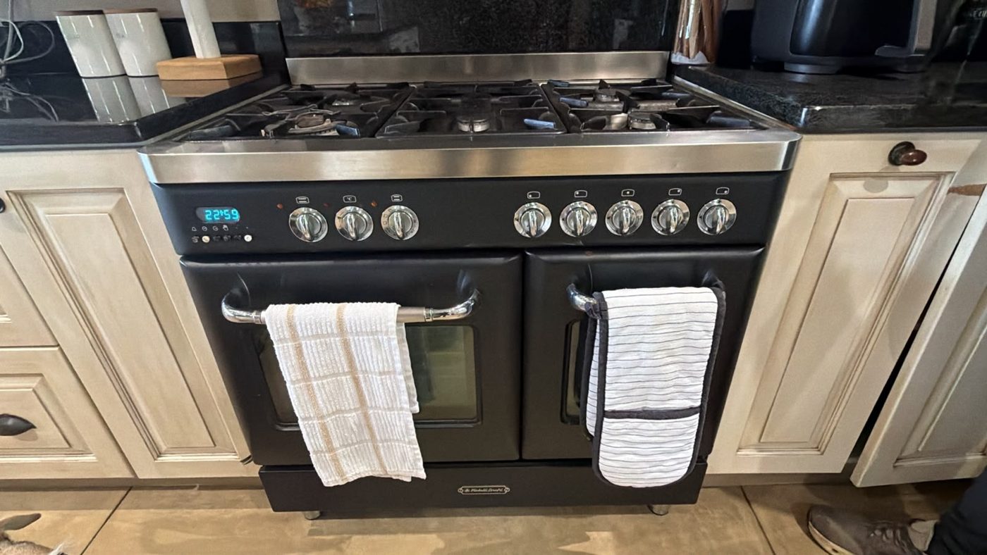 Dual-fuel range cooker with a five-burner gas hob in a Bryanston kitchen, where a cracked igniter caused electric shocks