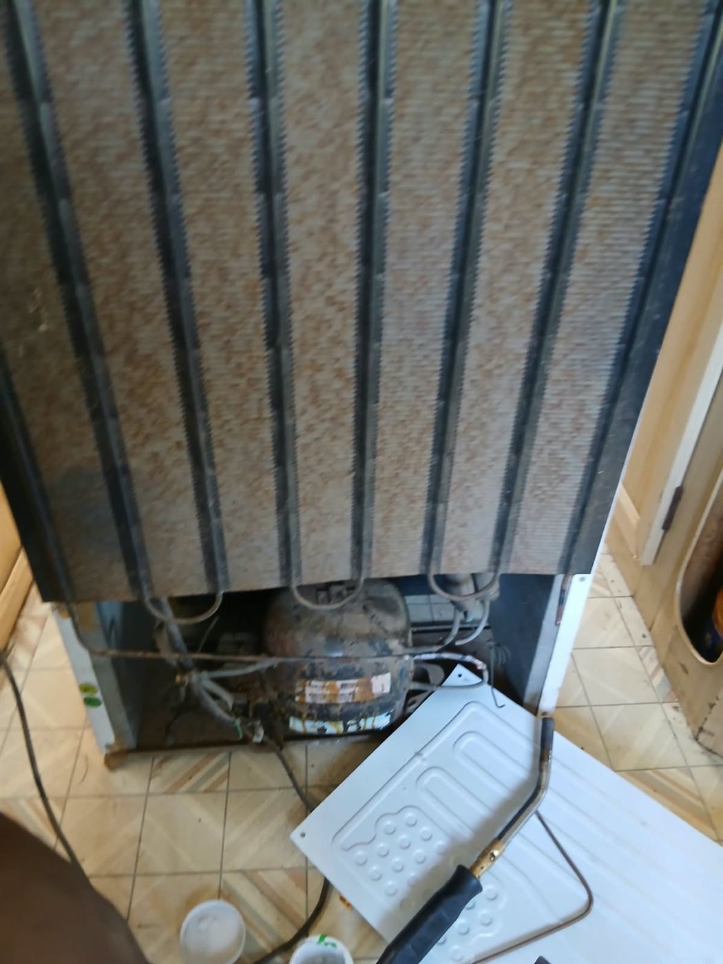 Back of a KIC caravan fridge opened up for a gas leak repair by brazing in Bedfordview