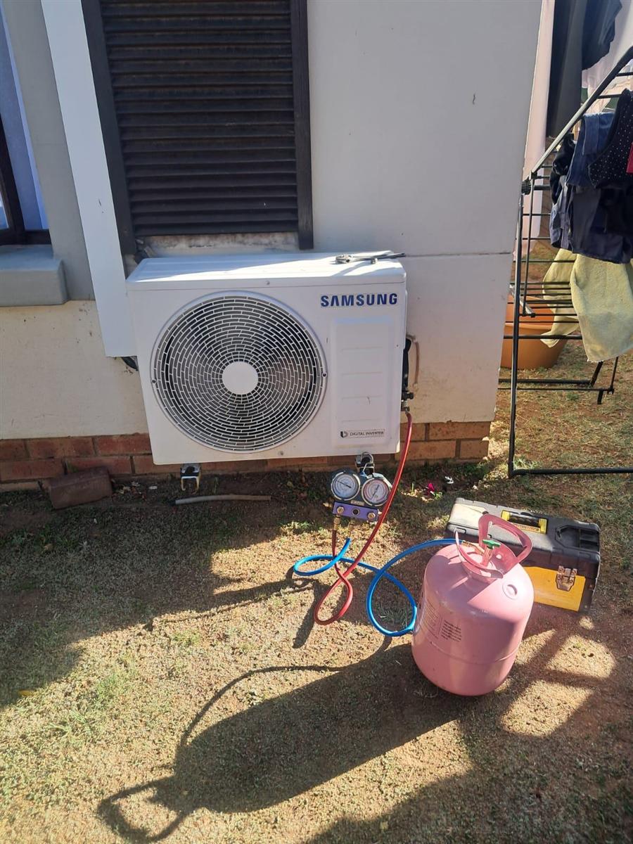 Gauges connected to a Samsung Digital Inverter outdoor unit to check gas pressures and regas it during an aircon service in Sandton