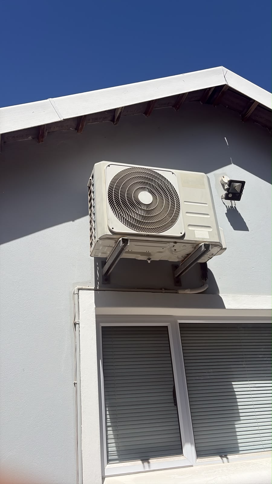 Split aircon outdoor unit on a wall bracket in Germiston, serviced because it was not cooling