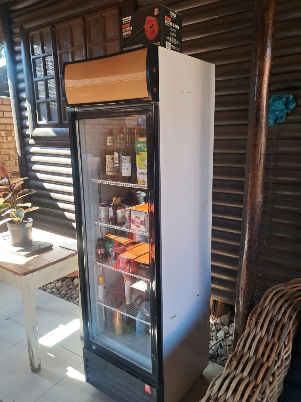Glass-door drinks cooler in a Steyn City entertainment area, repaired after a gas leak