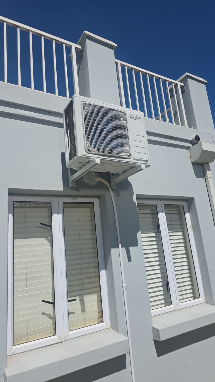Unitherm split aircon outdoor unit on wall brackets after a back-to-back installation in Midrand