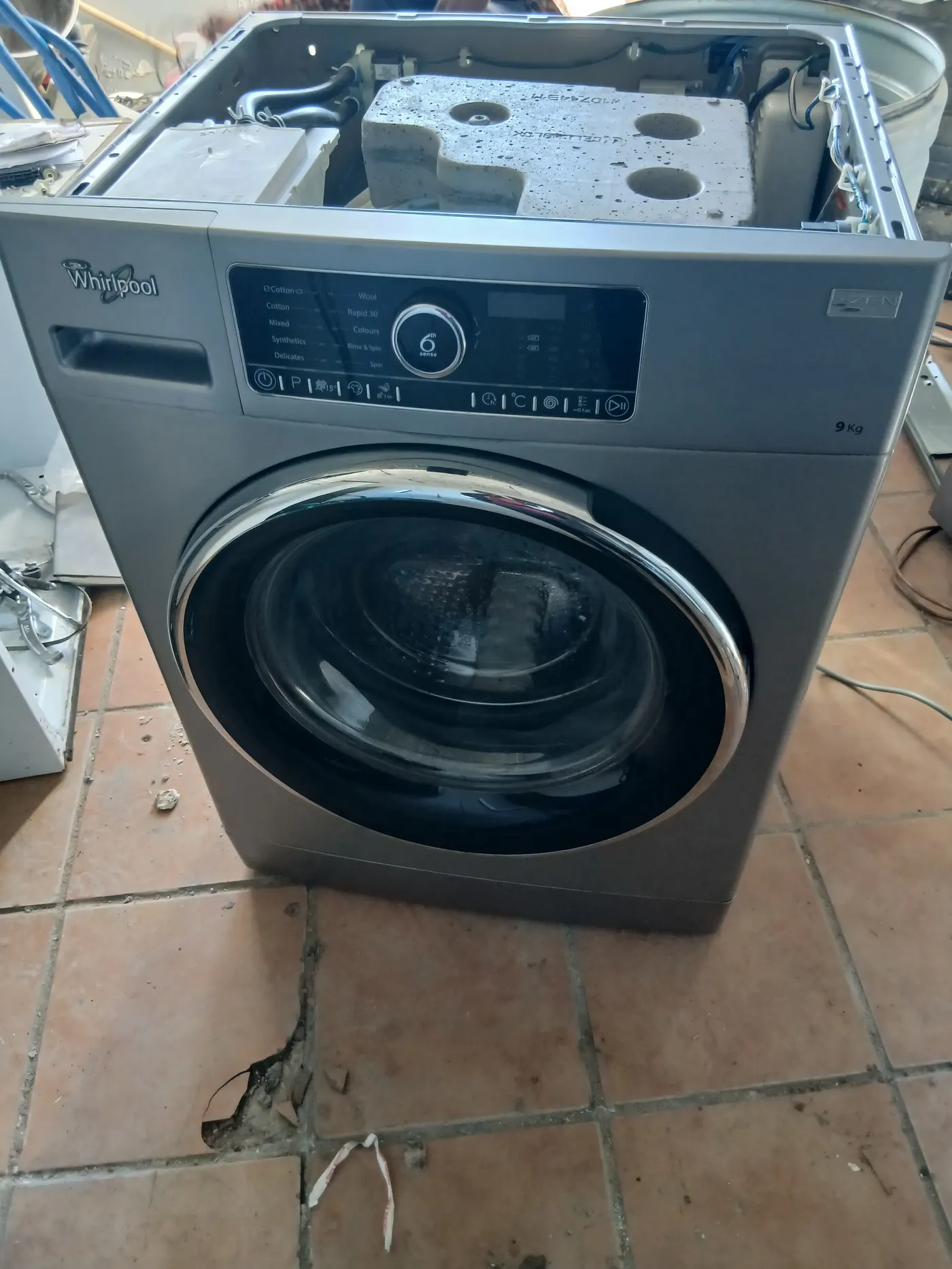 Whirlpool 6th Sense 9kg front-loading washing machine opened for repair in Gauteng